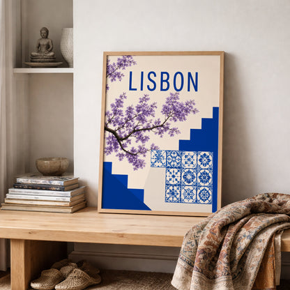 Lisbon art print styled on a shelf with soft folded textiles and neutral home decor. The poster shows Portuguese blue tile patterns, purple jacaranda flowers, city steps and clean Lisbon lettering, creating a relaxed Portugal wall art piece for bedrooms, living rooms and travel themed spaces.

Original filename: VIDEO
