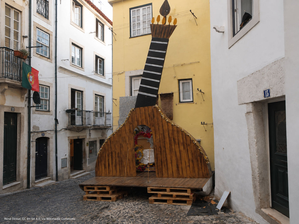 Large Portuguese guitar installation in a narrow Lisbon street in Portugal
