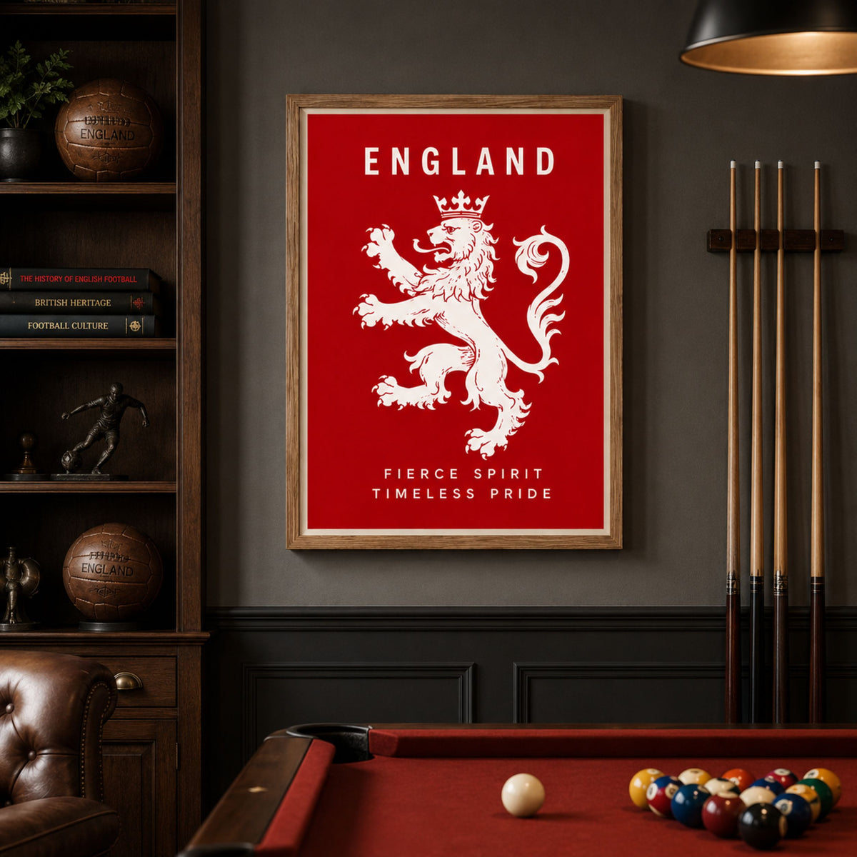 A framed England sports poster featuring a white lion rampant on a red background with the text 'ENGLAND' and 'FIERCE SPIRIT TIMELESS PRIDE', displayed on a dark wall above a pool table in a billiards room.