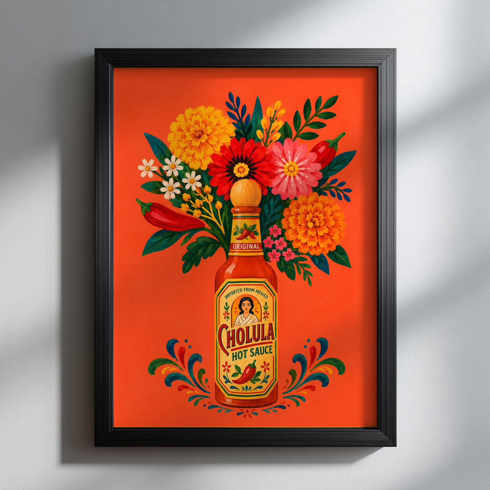 Mexican hot sauce bottle and flower art print displayed in a deep black frame on a light grey wall, with soft directional shadows highlighting the bright orange, red, yellow, pink and green design.