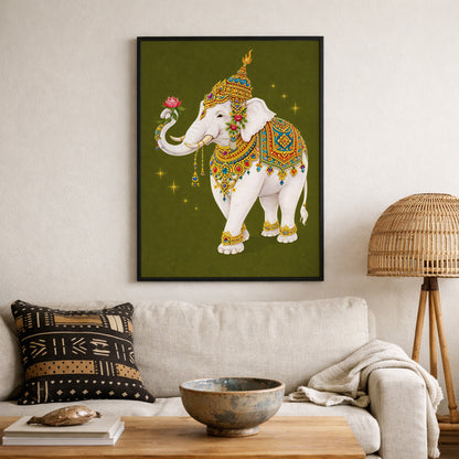 Thai royal white elephant artwork framed and displayed on a living room wall above a neutral sofa. The sacred white elephant wears intricate gold and jewel-toned ceremonial regalia and holds a pink lotus. Set against an olive green background, the print introduces traditional Thai royal symbolism into a modern, culturally inspired interior space.