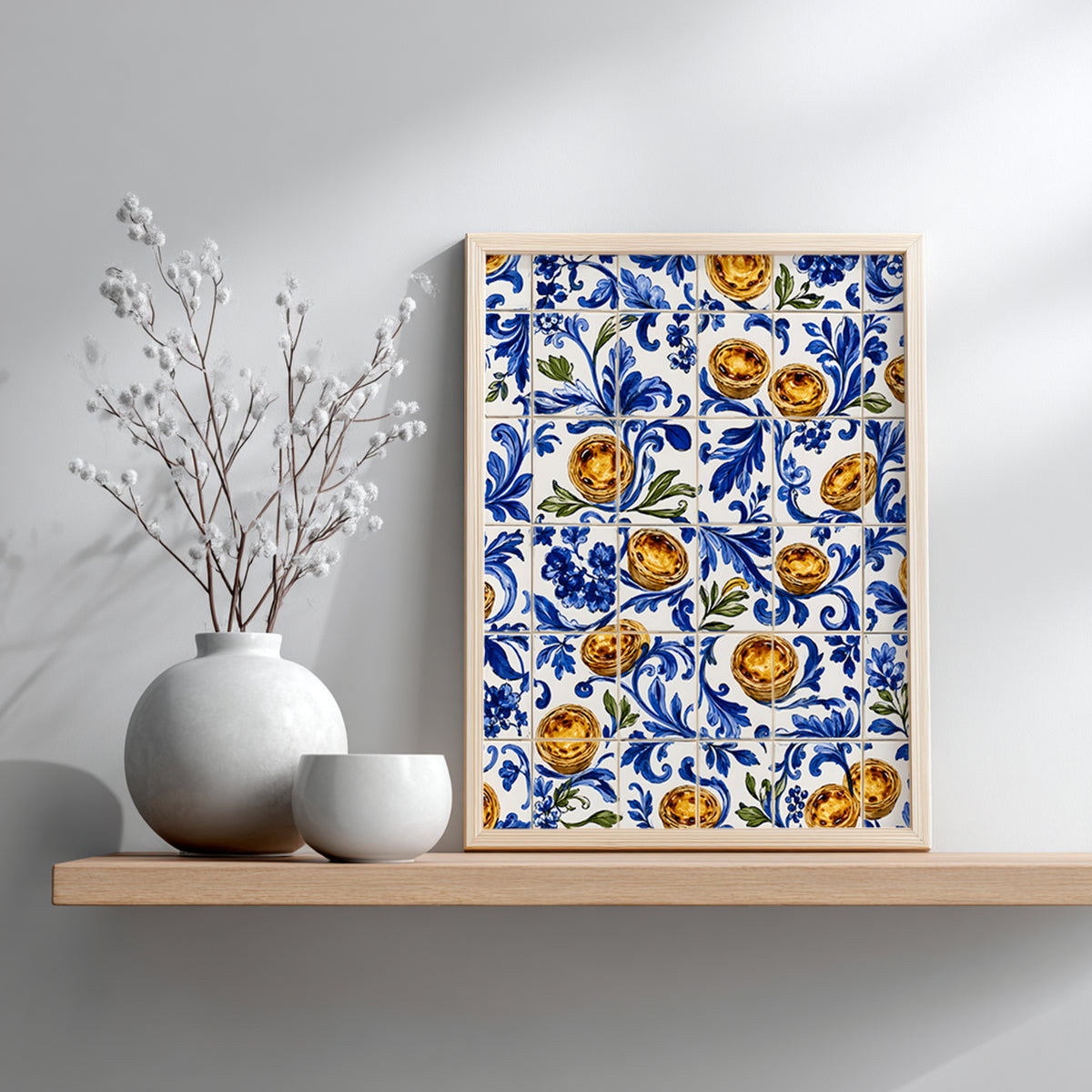 Small wooden framed Portuguese azulejo print featuring blue floral tiles and pastel de nata, displayed on a wooden shelf against a soft grey wall beside a decorative vase.