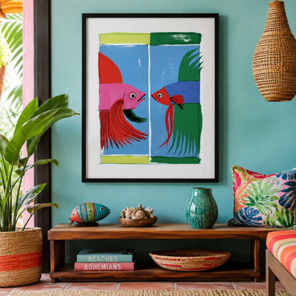 Colourful Thai fighting fish print displayed in a black frame above a wooden cabinet in a collected living room with a green wall, plants and decorative objects.