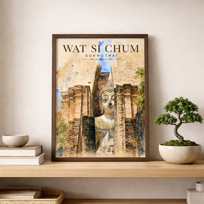 Framed Wat Si Chum Sukhothai print displayed above a wooden shelf beside a small bonsai plant, featuring the famous seated Buddha and ancient Thai temple brickwork.