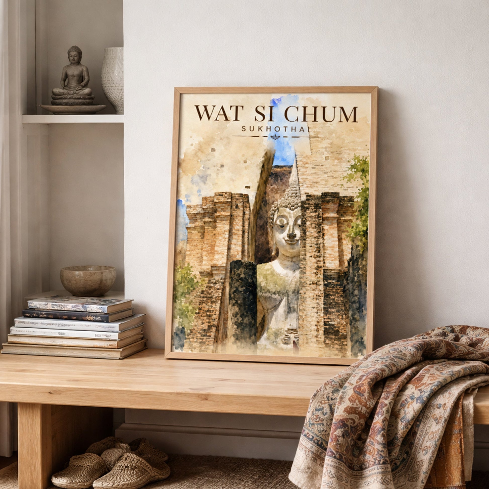 Wat Si Chum Thai temple art print displayed on a shelf in a neutral interior, featuring the seated Sukhothai Buddha among weathered brick ruins in warm earthy watercolour tones.