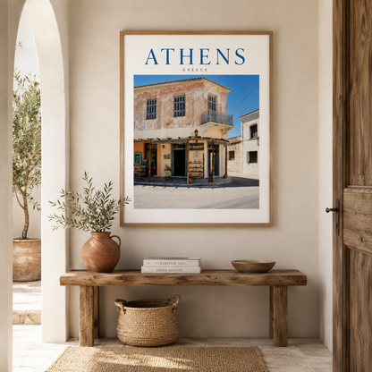 Athens photography print in a light wooden frame above a neutral console table, styled with natural ceramics in a warm, realistic home interior.