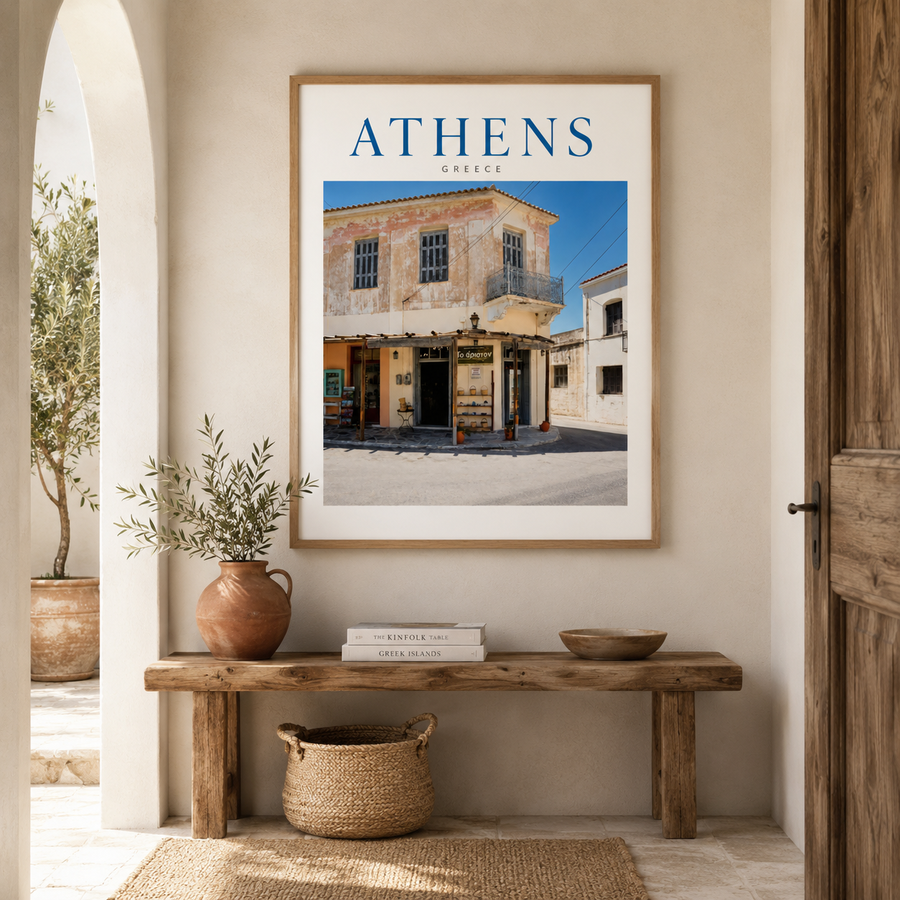 Athens photography print in a light wooden frame above a neutral console table, styled with natural ceramics in a warm, realistic home interior.