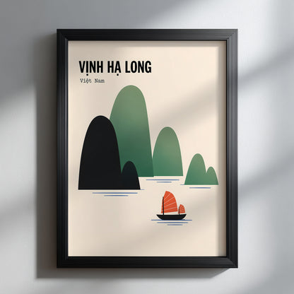 Ha Long Bay Vietnam travel poster presented in a slim black frame against a soft grey interior. Window light casts gentle shadows across the wall and surface, while the cream artwork, layered green limestone islands and orange junk boat stand out as clean, modern travel wall art.
