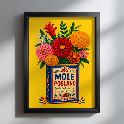 Mexican mole poblano wall art displayed in a slim black frame against a clean grey wall. The bright yellow print, blue vintage food tin and large red, pink and orange flowers stand out clearly, showing how this colourful Mexico poster can add strong contrast to a modern kitchen, dining room or gallery wall.