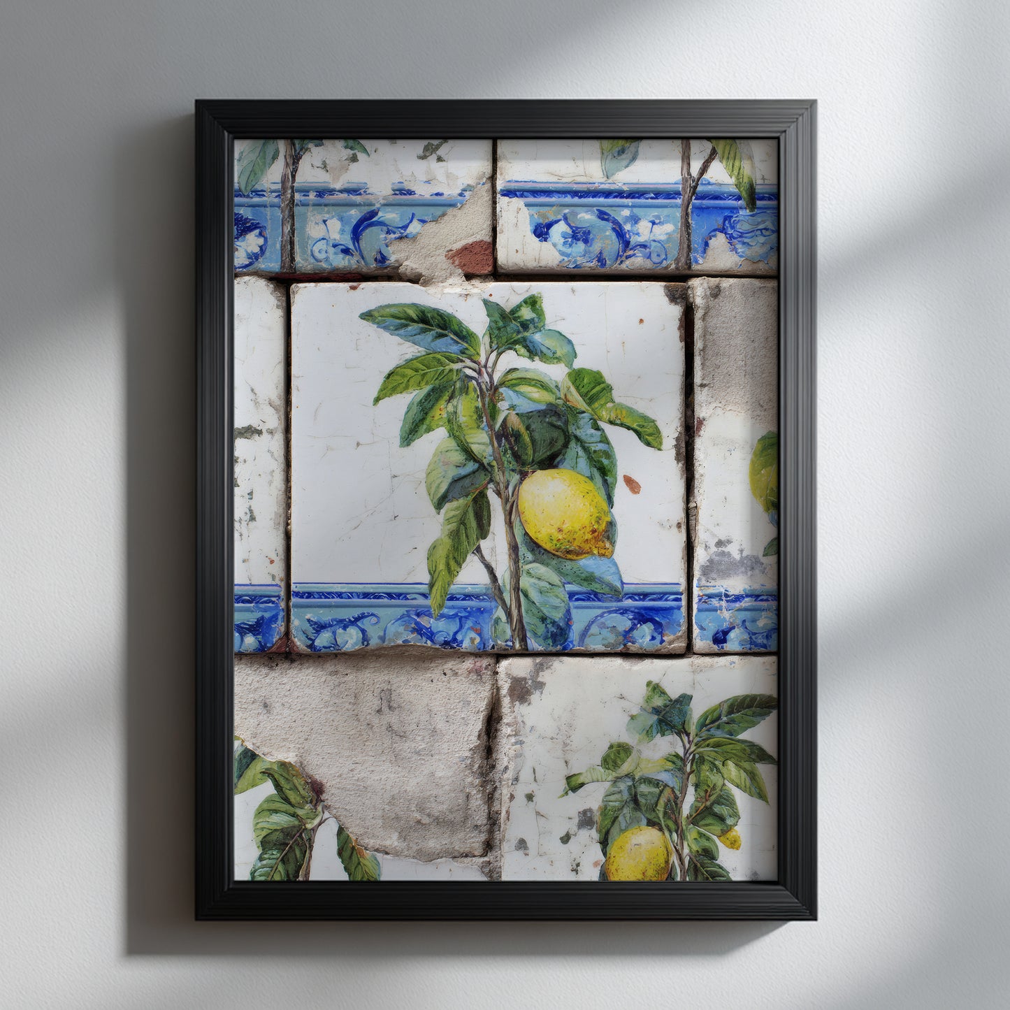 Portuguese lemon azulejo art print displayed in a black frame on a white wall, showing yellow citrus fruit, green leaves and weathered blue-and-white tiles.