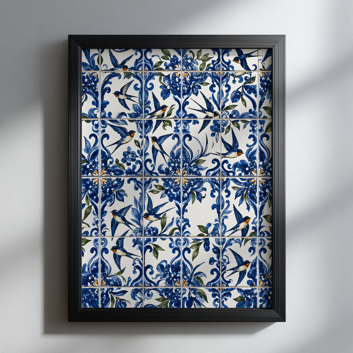 Portuguese swallow azulejo print in a black frame on a white wall, featuring blue and white ceramic tile patterns, floral details and flying andorinha swallows.