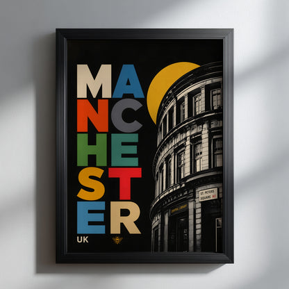 Bold Manchester Central Library wall art in a slim black frame on a light grey wall, showing colourful stacked typography, a yellow circle and monochrome curved architecture.