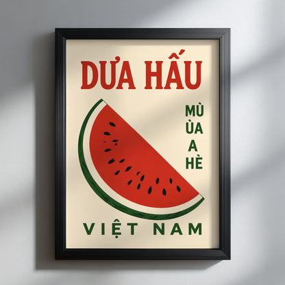 Black framed Vietnam watermelon poster shown facing forward on a clean white wall. The print features red Vietnamese DƯA HẤU text, green VIỆT NAM lettering and a bold watermelon illustration, giving a simple fruit poster look for modern kitchen wall art or dining room decor.