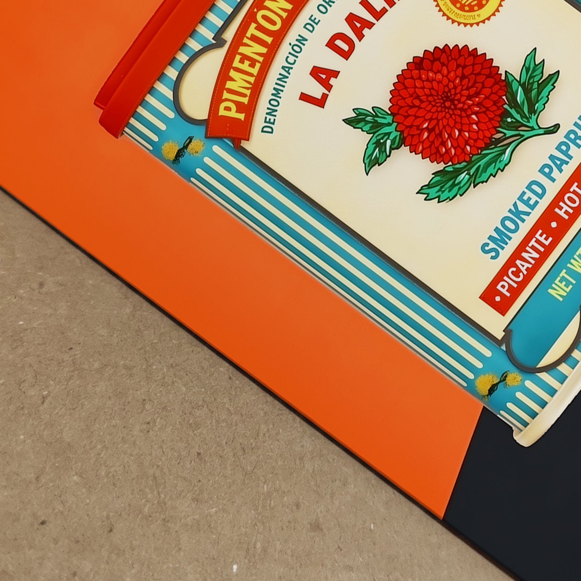 Detailed close-up of the framed Spanish Smoked Paprika Tin artwork showing print depth, frame edge and paper surface in a real-life setting. The image focuses on the corner area of the orange design and vintage tin layout, helping show finish and presentation. Useful for Spanish food packaging art, retro kitchen print detail, framed wall decor and bold graphic artwork with a clean professional look.