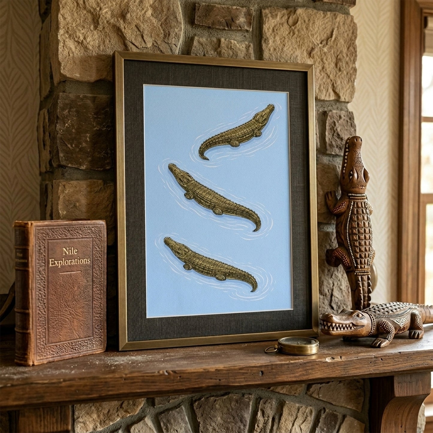 Framed crocodile wildlife print positioned on a stone fireplace mantel alongside books and decor objects. Three saltwater crocodiles are arranged diagonally on a soft blue field, illustrated in detailed zoological style. A statement reptile wall art piece suited to heritage interiors, home offices and natural history themed decor.