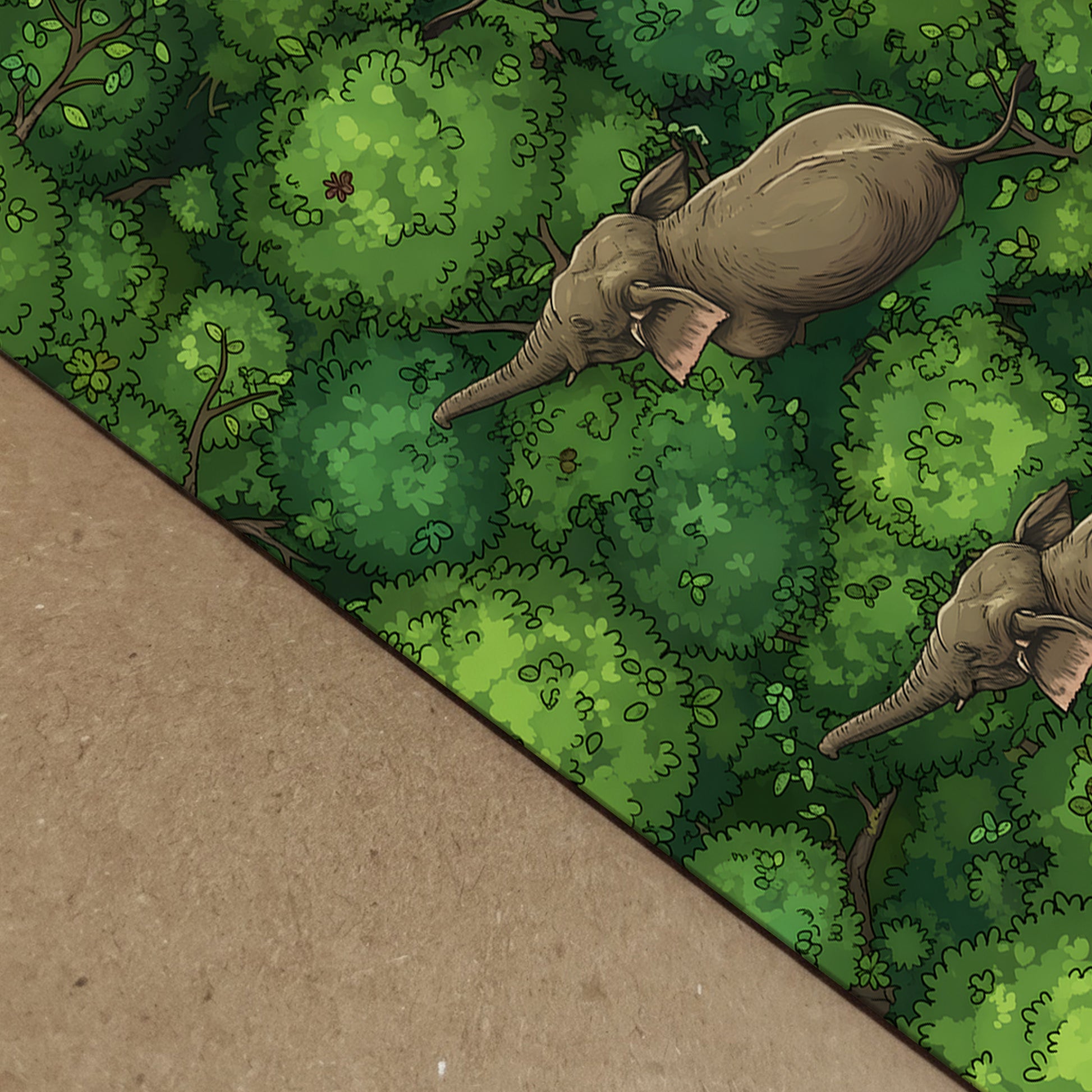 Close-up product image showing the elephant jungle artwork printed on paper with visible edge depth against a brown backing board. The design shows three elephants moving through rich green jungle canopy from above, highlighting the detail, colour and print surface. Useful for elephant art print, jungle animal poster, green wildlife artwork and paper quality listing images.