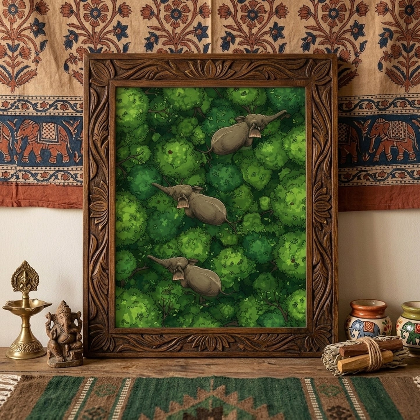 Framed elephant wall art displayed above a desk against a patterned textile backdrop. The print shows three elephants walking through dense green jungle canopy seen from above, adding a bold natural focal point to the room. Styled with warm earthy decor for travel-inspired interiors, this mockup suits elephant poster, jungle wall art, wildlife print and tropical animal wall decor product listings.