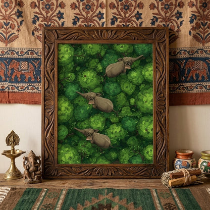 Framed elephant wall art displayed above a desk against a patterned textile backdrop. The print shows three elephants walking through dense green jungle canopy seen from above, adding a bold natural focal point to the room. Styled with warm earthy decor for travel-inspired interiors, this mockup suits elephant poster, jungle wall art, wildlife print and tropical animal wall decor product listings.