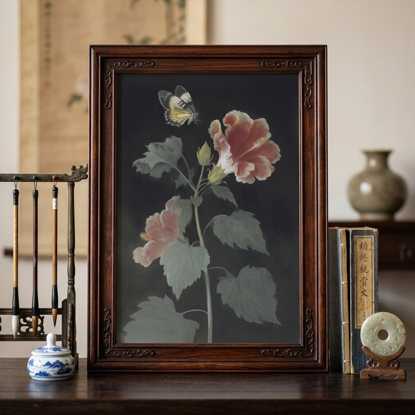 Malaysian hibiscus botanical wall art in a dark wood frame placed in a styled living room setting. The artwork shows Bunga Raya flowers and a Rajah Brooke’s Birdwing butterfly on a dark background. Vintage botanical wall art styled with classic décor, creating a calm and elegant focal point in the space.