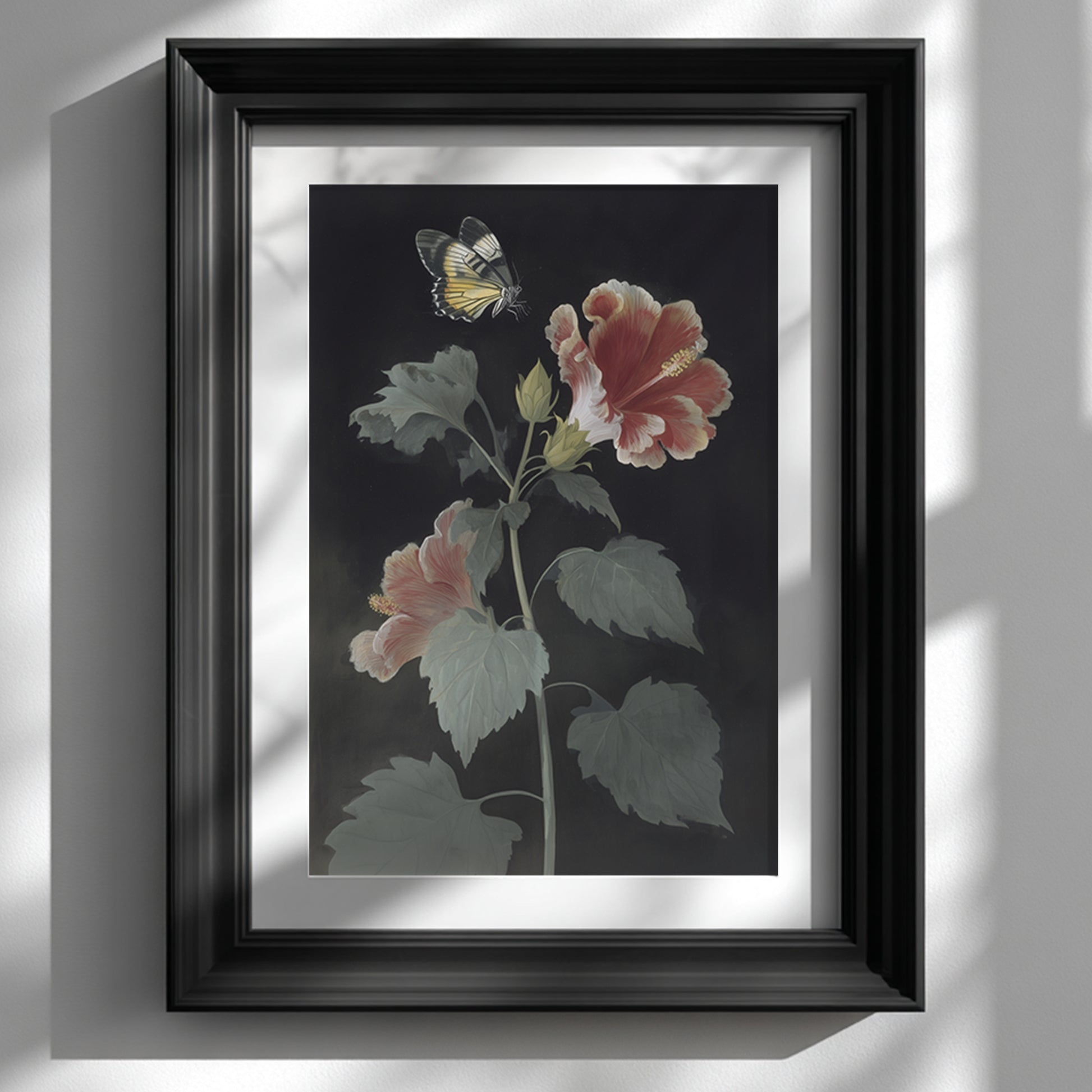 Framed Malaysian hibiscus and Rajah Brooke’s Birdwing butterfly wall art displayed on a clean white wall in a black frame. The botanical print shows a tall hibiscus plant with red and pink petals and a yellow butterfly above the flower, creating a vintage botanical wall art look with strong contrast and minimal styling.