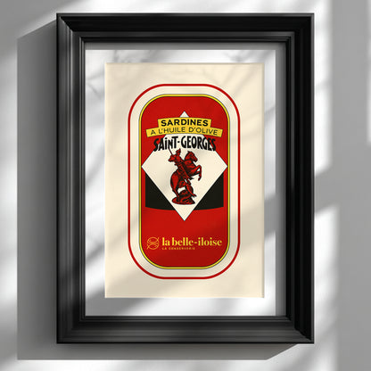 French sardine tin pop art print in a deep black frame on a white wall, with soft window shadows highlighting the red, cream, yellow and black vintage packaging design.