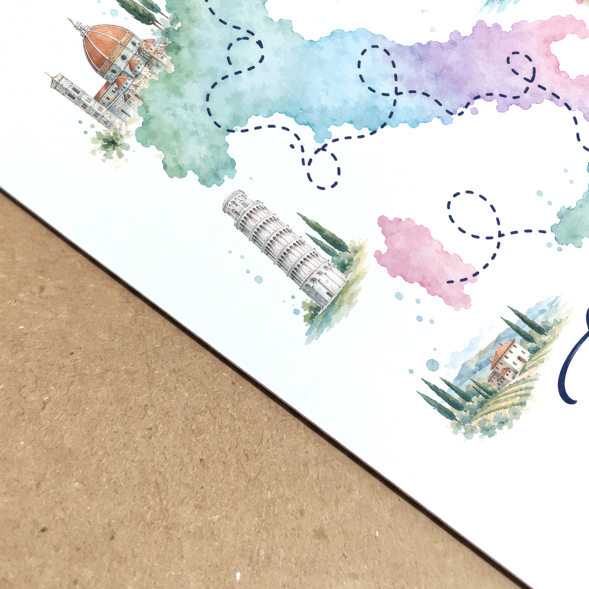 Close-up view of the Italy map poster printed on white paper and placed over a natural kraft surface. The angled composition highlights the crisp edge, paper finish, pastel watercolour regions, dotted travel route and small illustrated Italian scenes, showing the detail and texture of this colourful Italy travel print.