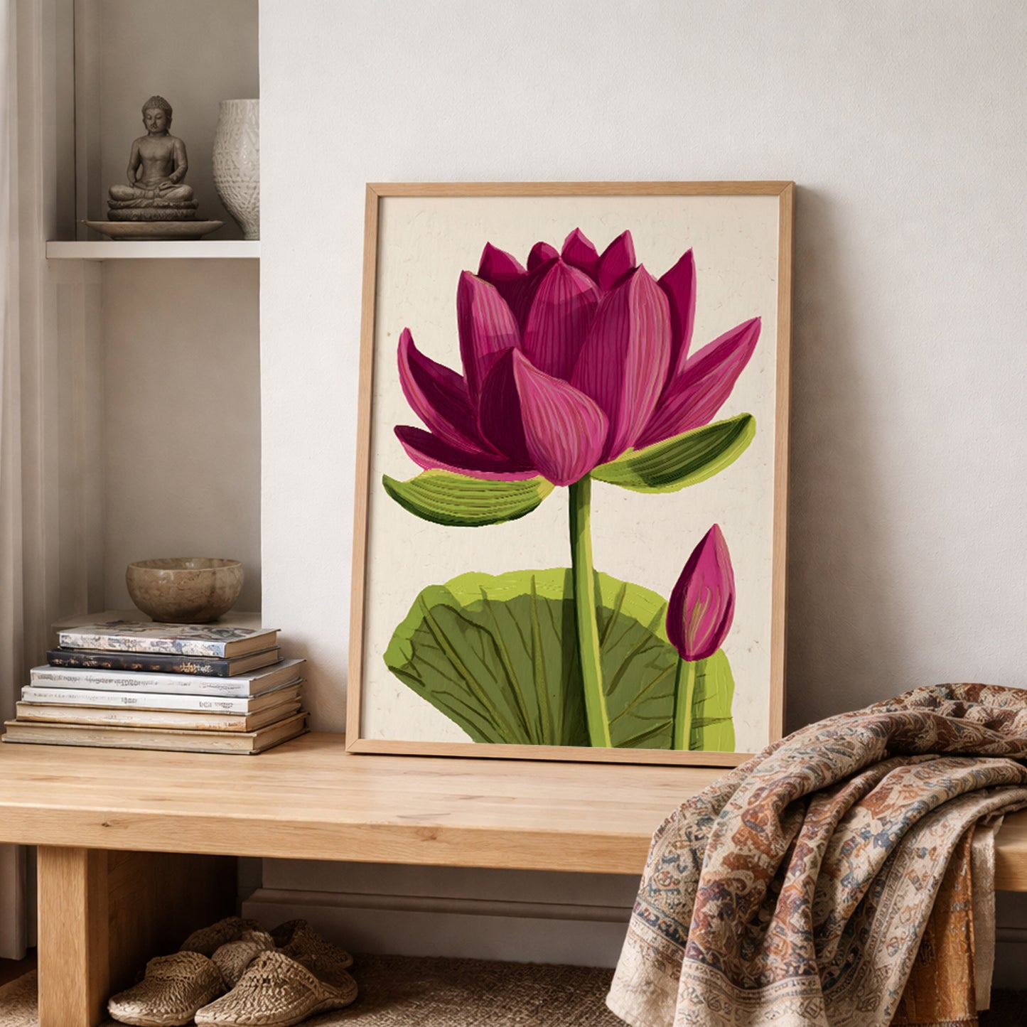 Pink lotus wall art print resting on a wooden shelf with stacked books and folded textiles. The design shows a large pink lotus flower in bloom with detailed petals, green stem, broad leaf and small bud on a neutral background. East Asian inspired botanical decor for minimalist bedrooms and peaceful living spaces.
