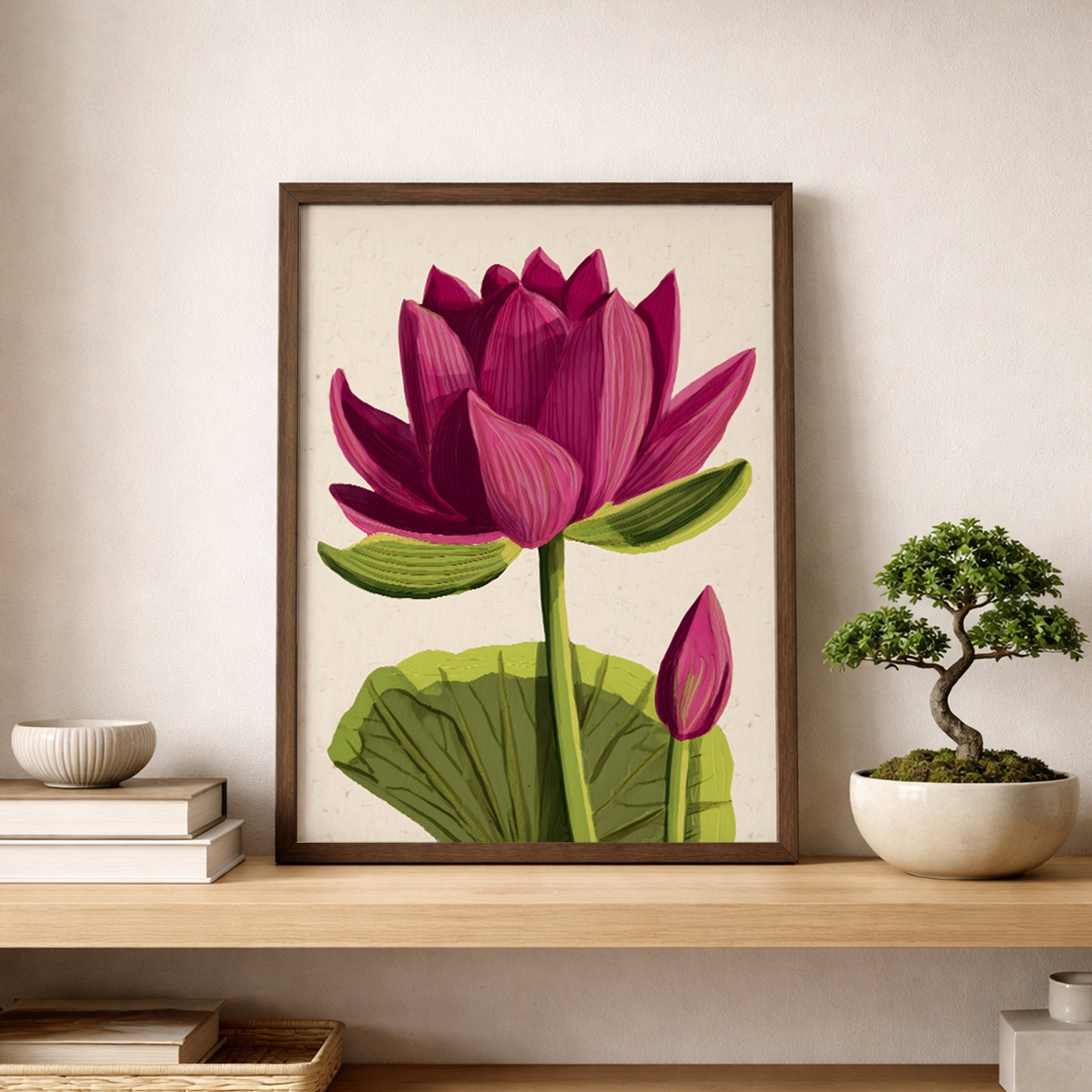 Pink lotus flower poster styled on a wooden shelf beside a small bonsai plant. The print features a full pink lotus bloom with layered petals, green stem and broad leaf on a soft beige background. Botanical lotus wall art suited for zen interiors, yoga studios and calm bedroom decor.