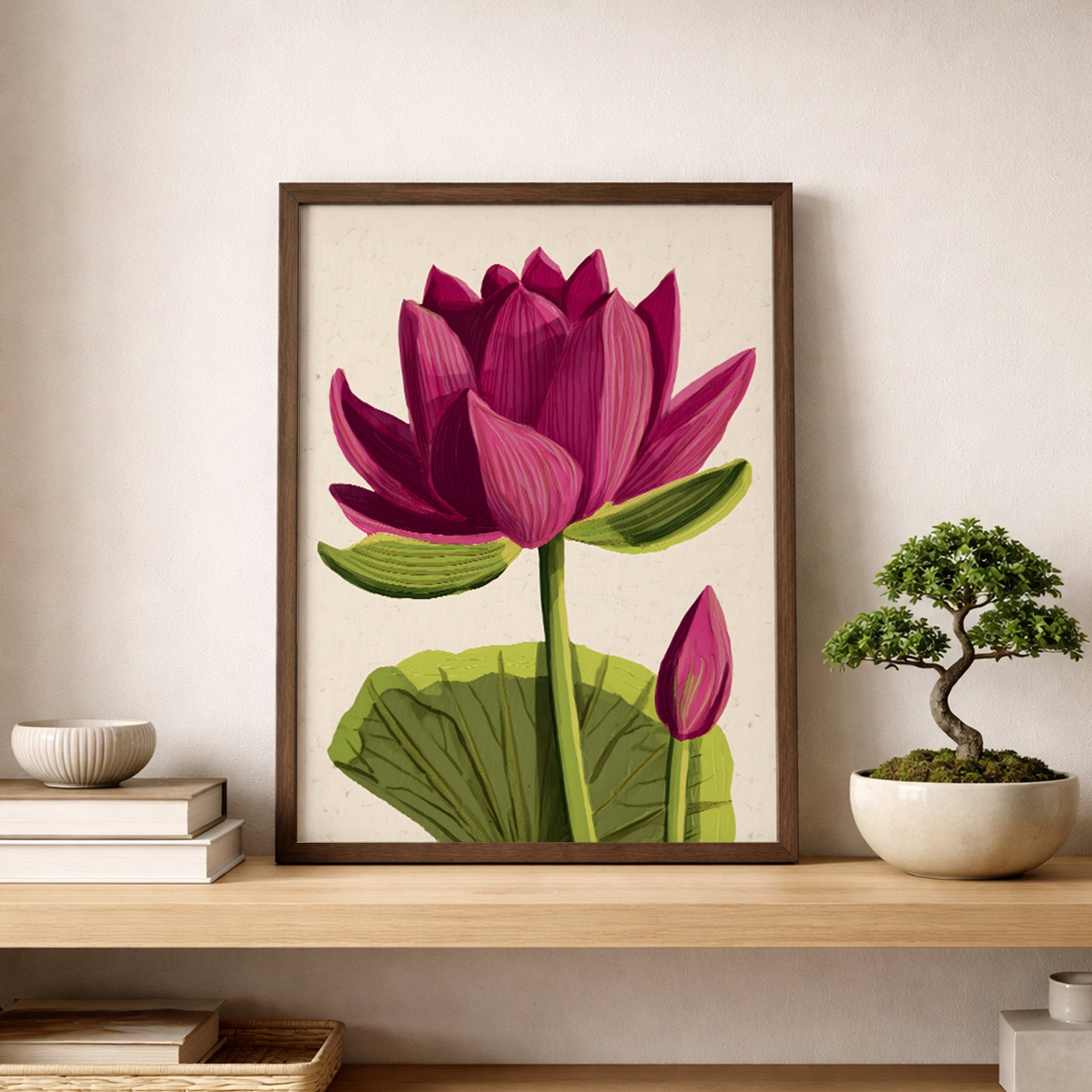 Pink lotus flower poster styled on a wooden shelf beside a small bonsai plant. The print features a full pink lotus bloom with layered petals, green stem and broad leaf on a soft beige background. Botanical lotus wall art suited for zen interiors, yoga studios and calm bedroom decor.