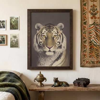 Framed Malayan tiger wall decor styled above a bedroom surface with neutral tones and minimal furnishings. The big cat portrait features a direct gaze, detailed fur and muted brown backdrop in a vintage photography style. Wildlife wall art adds a strong yet calm focal point suited to modern bedroom interiors.