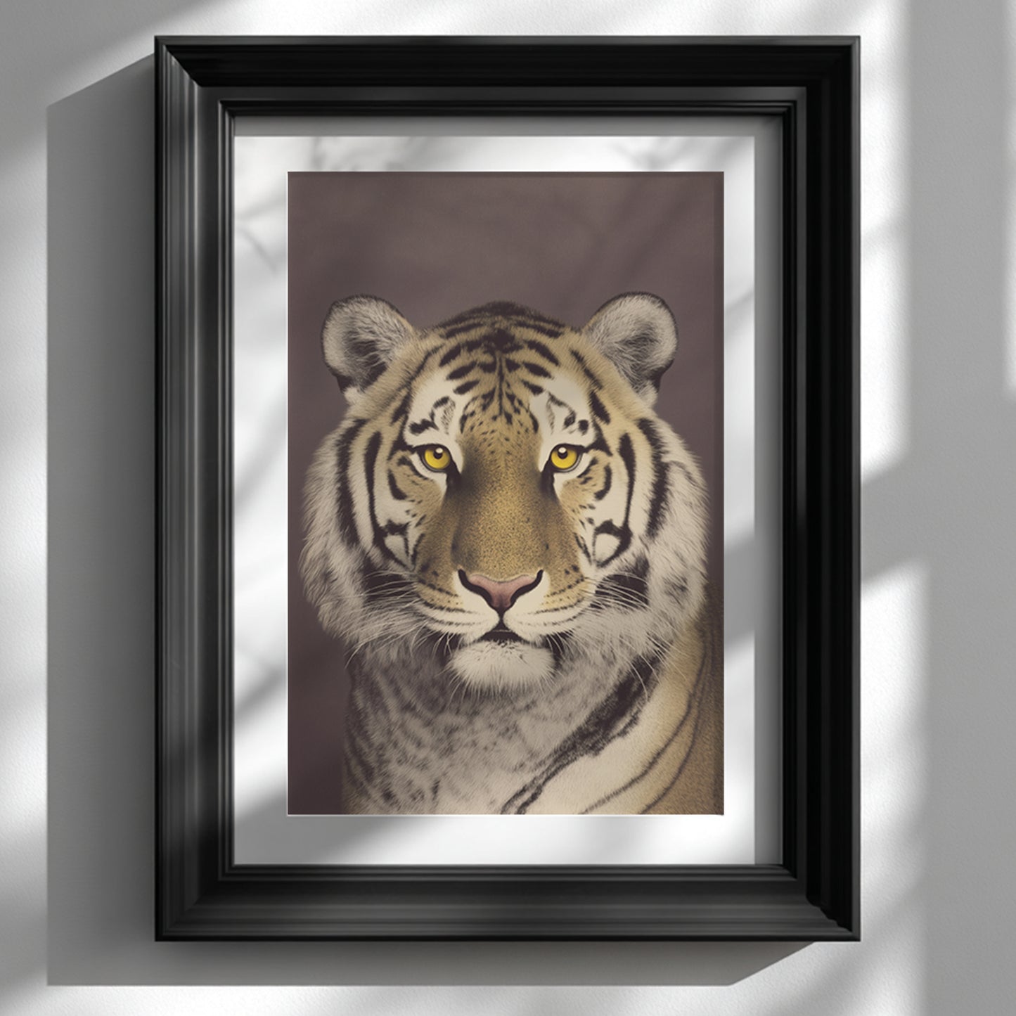Framed Malayan tiger wall art displayed in a black frame against a clean white wall. The close-up tiger portrait shows a calm front-facing gaze with detailed fur, bold black stripes and warm brown background tones. Vintage photographic style wildlife art styled in a modern interior setting with natural light and soft shadow for contemporary home decor inspiration.