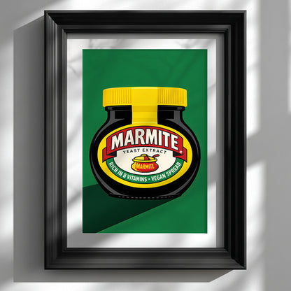 Framed Marmite Jar Print shown on a white wall in a glossy black frame with a wide white mount. The artwork features a black Marmite jar with a bright yellow lid, red and cream label, and green background in a bold pop art style. Clean lines, strong contrast and simple modern styling make it ideal for British kitchen wall art, contemporary food art and framed dining room decor.