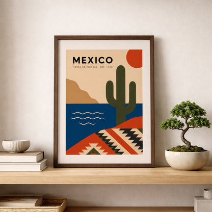Natural wood framed Mexico travel poster resting on a shelf beside stacked books and a small bonsai tree. The artwork features a green cactus, red sun, blue sea and geometric Mexican textile pattern, creating a warm cultural wall art display for a living room, bedroom, study or reading corner.