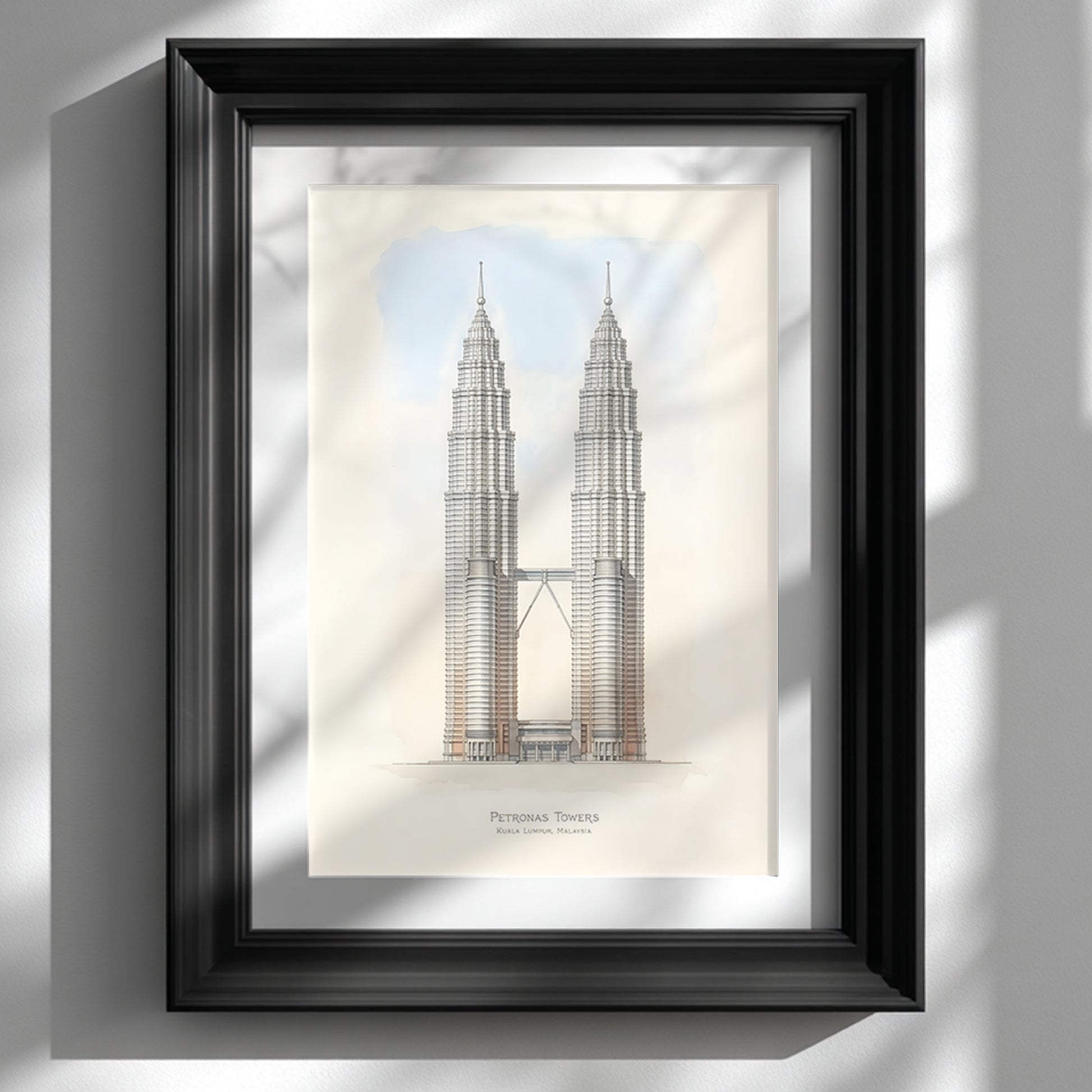 Framed Petronas Towers architectural line art print displayed in a black frame on a bright white wall. The illustration shows the Kuala Lumpur Petronas Twin Towers standing symmetrically with the connecting sky bridge and soft sky tones behind. Minimalist Malaysia architecture wall art featuring detailed skyscraper line work and neutral colours suited for modern interior decor.