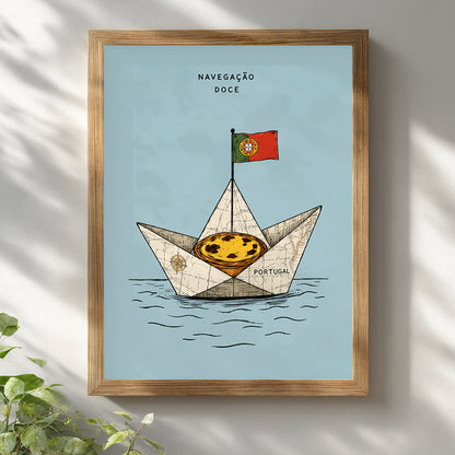 Pastel de nata sailing boat print displayed in a natural wooden frame on a white wall with soft sunlight and leafy shadows.
