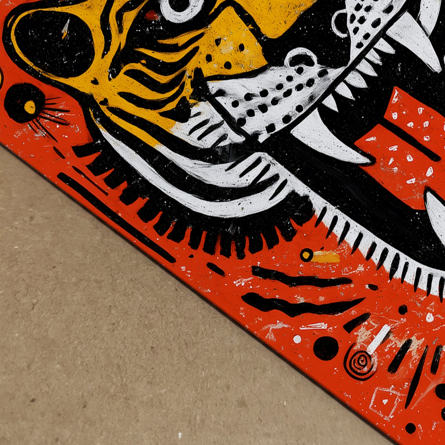 Detailed angled close-up of the Roaring Malayan Tiger poster showing paper texture and ink depth. The bold orange field and high contrast black and white striping highlight the open mouth, sharp teeth and red tongue. Tribal-style circular patterns add graphic interest, reinforcing the modern wildlife art print aesthetic.