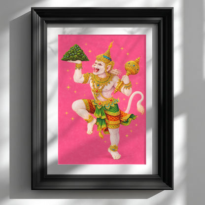 Thai Hanuman Ramakien art print displayed in a black frame against a clean white wall. The vibrant pink background highlights the Hindu monkey god in traditional Thai costume with gold detailing and green accents, captured mid-dance. A bold spiritual mythology poster styled as contemporary wall decor, blending Southeast Asian folklore with modern interior presentation.