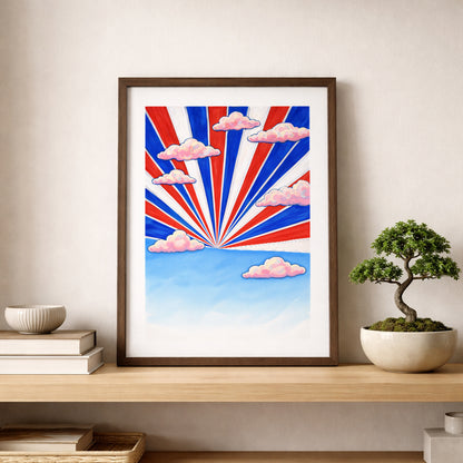 Framed Thai Sky Sunburst Thailand poster placed on a wooden shelf beside a bonsai plant. Red, white and blue rays radiate upward with pink clouds across a blue sky horizon. Modern Thailand travel art print styled as bold Southeast Asia decor for minimalist interiors.