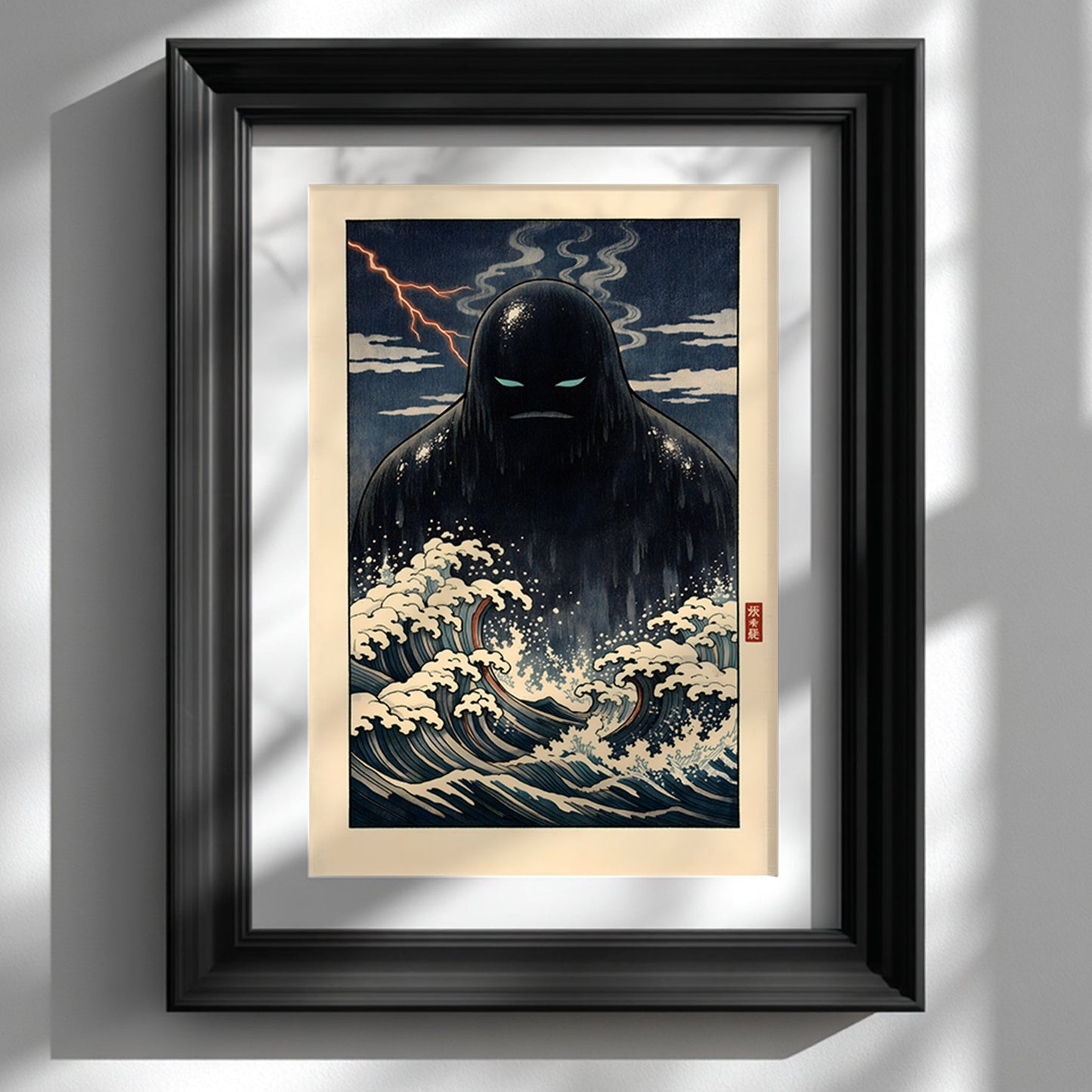 Framed Japanese yōkai wall art print featuring a dark Umibōzu sea spirit rising from stylised ocean waves, displayed in a black frame against a white wall. The artwork shows dramatic navy tones, foaming cream waves and a stormy night sky inspired by traditional Japanese woodblock aesthetics. A bold folklore statement piece for modern interiors and cultural art collections.