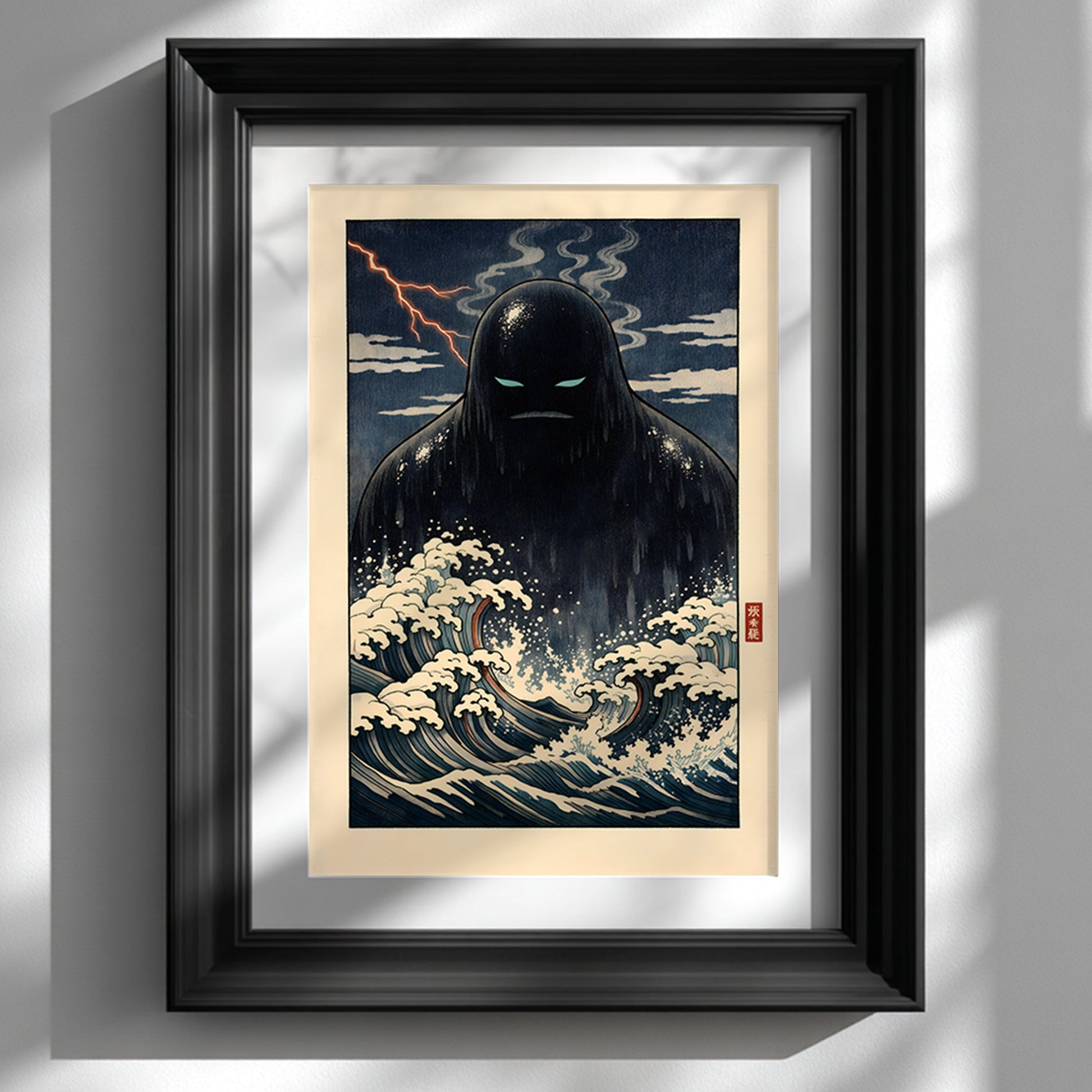 Framed Japanese yōkai wall art print featuring a dark Umibōzu sea spirit rising from stylised ocean waves, displayed in a black frame against a white wall. The artwork shows dramatic navy tones, foaming cream waves and a stormy night sky inspired by traditional Japanese woodblock aesthetics. A bold folklore statement piece for modern interiors and cultural art collections.