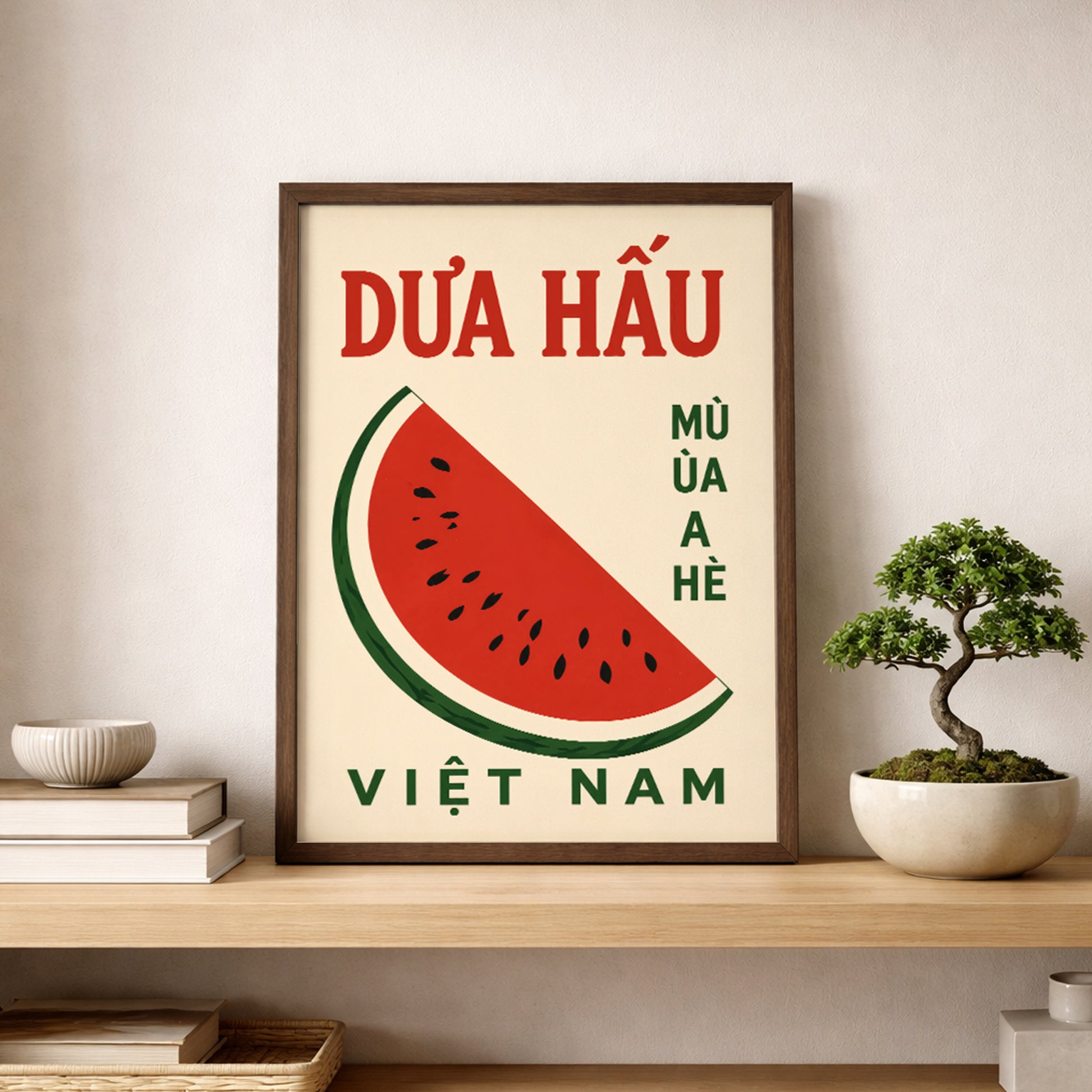 Vietnam watermelon poster displayed on a shelf beside a small green plant in a calm neutral room. The artwork has a cream background, bold red Vietnamese title, green text and a simple watermelon slice, making it a fresh fruit wall print for kitchen shelves, dining rooms or cafe decor.
