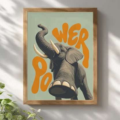 Wooden framed elephant wall art hanging on a white wall, featuring a grey elephant with raised trunk, large tusks, detailed texture and orange retro lettering on a soft green background. A bright safari animal poster for natural home decor, living room wall art, kids’ room decor or office wall styling.