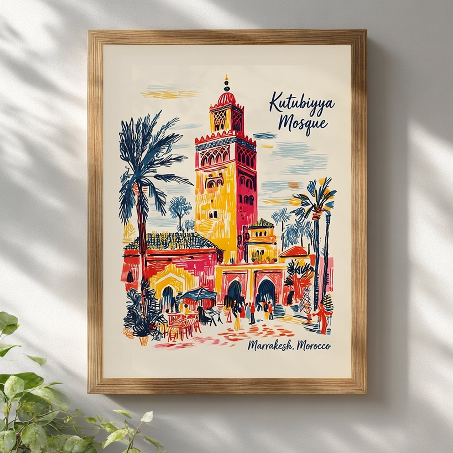  Kutubiyya Mosque print displayed in a light wood frame on a white wall with soft window shadows across the surface. The Marrakech artwork shows the mosque tower, palm trees, archways and small figures in a colourful travel poster style with red, yellow, blue and cream tones. A simple styled mockup for Morocco wall art and Moroccan architecture print placement in bright modern interiors.